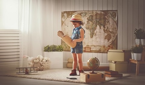 Concept travel. child girl at home dreaming of travel and tourism, exploring the world map and globe