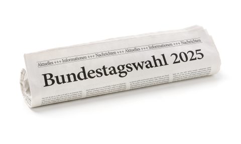 Zeitungsrolle mit der Überschrift Bundestagswahl 2025