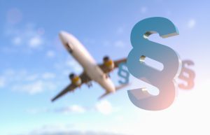 Paragraph / section sign against sky with airplane flying - Symbol of Law and Justice -