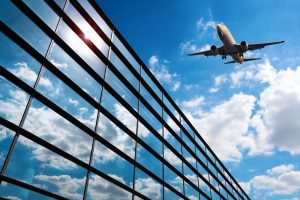 glass curtain wall and aircraft against a blue sky