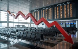 Empty International Airport Terminal with Cancelled Flights on Departure Board and Falling Financial Graph Overlay, Tourism and Aviation Industry Downturn Economic Crisis Concept