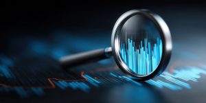 Close-up view of a magnifying glass revealing detailed financial statistics and market trends on a digital interface